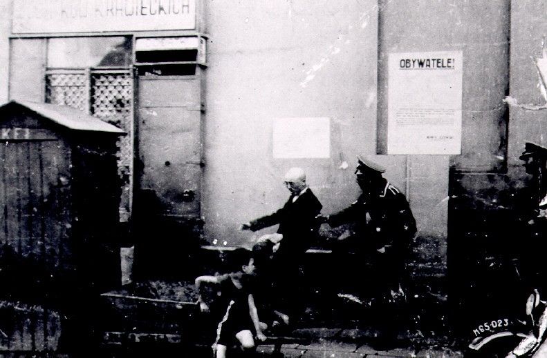 SS man kicking a Jew